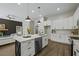 Bright modern kitchen features stainless appliances, white cabinets and a stylish island at 6971 Tan Bark Ct, Riverdale, GA 30296