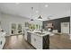 Open floor plan features a modern kitchen with island seating, dining area, and cozy living space at 6971 Tan Bark Ct, Riverdale, GA 30296
