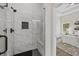 Modern bathroom features a glass-enclosed shower and a view into the main bedroom at 6971 Tan Bark Ct, Riverdale, GA 30296