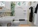Bright bathroom features a shower and tub combination, ceramic tiles and a pedestal sink at 733 Rice Nw St, Atlanta, GA 30318