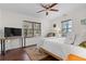 Bright bedroom features hardwood floors, a ceiling fan, and two large windows with natural light at 733 Rice Nw St, Atlanta, GA 30318