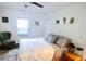 Cozy bedroom with a patterned duvet cover, area rug, houseplants, and a green accent chair at 733 Rice Nw St, Atlanta, GA 30318