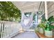 Relaxing front porch featuring hanging hammock chair and potted plants at 733 Rice Nw St, Atlanta, GA 30318