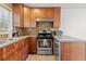 Functional kitchen with wood cabinets, stainless steel appliances, and modern fixtures at 733 Rice Nw St, Atlanta, GA 30318