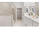 Modern bathroom showcasing a glass-enclosed shower, double vanity with white cabinets, and tiled floors at 1235 Cedarcrest Blvd, Acworth, GA 30101