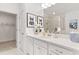 Stylish bathroom with a large mirror, white countertops, and access to the walk-in closet and glass enclosed shower at 1235 Cedarcrest Blvd, Acworth, GA 30101