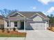 Charming one-story home with gray siding, a two-car garage, and a well-manicured front yard at 1235 Cedarcrest Blvd, Acworth, GA 30101