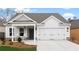 Charming single-story home featuring a two-car garage, covered porch, and beautifully landscaped front yard at 1235 Cedarcrest Blvd, Acworth, GA 30101
