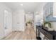 Bright hallway featuring wood floors, neutral paint, and an open view into the dining and living area at 1235 Cedarcrest Blvd, Acworth, GA 30101