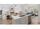 Open kitchen featuring a large island with sink and seating, stainless steel appliances, and views into the living room at 1235 Cedarcrest Blvd, Acworth, GA 30101