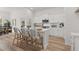 Open-concept kitchen with an island, white cabinetry, stainless steel appliances, and views into the dining area at 1235 Cedarcrest Blvd, Acworth, GA 30101