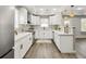 Bright, modern kitchen featuring white cabinets, stainless steel appliances, and hardwood flooring at 1406 Kennesaw Nw Dr, Atlanta, GA 30318