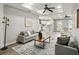 Open-concept living room flows into kitchen, featuring neutral walls, modern lighting, and comfortable seating at 1406 Kennesaw Nw Dr, Atlanta, GA 30318