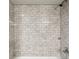 Close up of bathroom shower with new white subway tile at 1406 Kennesaw Nw Dr, Atlanta, GA 30318