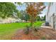Spacious backyard with lush green grass, mature trees, and a glimpse of neighboring houses at 1624 River Main Ct, Lawrenceville, GA 30046