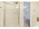Bathroom featuring a glass door shower and a view of a bedroom with natural light at 1624 River Main Ct, Lawrenceville, GA 30046