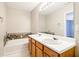 Spacious bathroom with dual sinks and a tiled backsplash at 1624 River Main Ct, Lawrenceville, GA 30046
