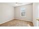 Simple bedroom features neutral walls, carpet, and natural light at 1624 River Main Ct, Lawrenceville, GA 30046