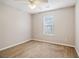 Cozy carpeted bedroom featuring natural light from the window at 1624 River Main Ct, Lawrenceville, GA 30046