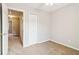 A carpeted bedroom with a closet at 1624 River Main Ct, Lawrenceville, GA 30046