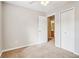 This carpeted bedroom features a ceiling fan, neutral walls, and access to the bathroom at 1624 River Main Ct, Lawrenceville, GA 30046