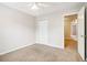 Carpeted bedroom featuring a ceiling fan and a closet with white doors at 1624 River Main Ct, Lawrenceville, GA 30046