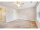 Spacious carpeted bedroom featuring a ceiling fan, a window, and closet at 1624 River Main Ct, Lawrenceville, GA 30046