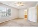 Carpeted bedroom featuring a bright window and adjacent bathroom access at 1624 River Main Ct, Lawrenceville, GA 30046