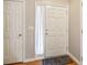 Bright entryway features a white front door with a storm door and a white closet door at 1624 River Main Ct, Lawrenceville, GA 30046