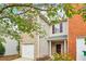 Two-story house with brick and siding exterior, attached garage, and well-kept landscaping at 1624 River Main Ct, Lawrenceville, GA 30046