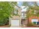 Charming two-story brick home with attached one-car garage and mature trees in front at 1624 River Main Ct, Lawrenceville, GA 30046