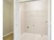 An empty laundry room with white walls, a single wire shelf, and standard hookups ready for appliances at 1624 River Main Ct, Lawrenceville, GA 30046