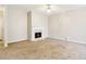 Cozy living room with fireplace, plush carpet, and neutral paint at 1624 River Main Ct, Lawrenceville, GA 30046
