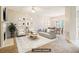Staged living room area with fireplace, view of dining area, and natural light at 1624 River Main Ct, Lawrenceville, GA 30046
