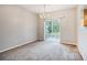 A cozy living room with carpet, a sliding glass door, and a chandelier at 1624 River Main Ct, Lawrenceville, GA 30046