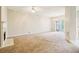 Spacious living room featuring plush carpet, fireplace, and sliding glass doors to the backyard at 1624 River Main Ct, Lawrenceville, GA 30046