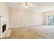 Bright and airy living room features plush carpet, fireplace, and natural lighting at 1624 River Main Ct, Lawrenceville, GA 30046