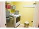 Bright laundry room features modern washer, dryer, and storage shelves at 205 Ashebourne Trl, Alpharetta, GA 30005