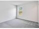 A bedroom featuring light gray carpeting, a window with natural light, and neutral walls at 207 Groveton Ct, Euharlee, GA 30145