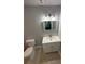 This bathroom features modern fixtures, a sleek vanity, and an updated toilet, creating a clean and stylish space at 2405 Cross Nw St, Atlanta, GA 30318