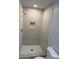 Updated bathroom showcases sleek shower with tiled walls and a modern showerhead, offering a spa-like experience at 2405 Cross Nw St, Atlanta, GA 30318