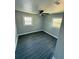 Bedroom featuring gray walls, modern ceiling fan, sleek gray flooring and dual windows at 2405 Cross Nw St, Atlanta, GA 30318