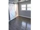 Bedroom with modern gray flooring, neutral walls, and barn door leading to en-suite bathroom at 2405 Cross Nw St, Atlanta, GA 30318