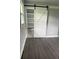 Bedroom features an en-suite bathroom, a sliding barn door and modern gray vinyl flooring at 2405 Cross Nw St, Atlanta, GA 30318