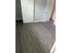 Bedroom featuring durable modern gray flooring, barn door and white painted trim at 2405 Cross Nw St, Atlanta, GA 30318