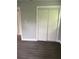 Bedroom featuring modern gray flooring, a large double closet, and neutral paint at 2405 Cross Nw St, Atlanta, GA 30318