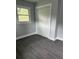 A spacious bedroom featuring light gray walls, new vinyl floors and a large closet at 2405 Cross Nw St, Atlanta, GA 30318