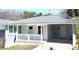 Charming home featuring a freshly painted exterior, covered carport, and light green front door at 2405 Cross Nw St, Atlanta, GA 30318