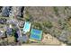 Aerial shot of community amenities including a pool, tennis courts, and playground surrounded by lush greenery at 5470 Beaver Ridge Dr, Cumming, GA 30040