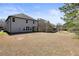 Two-story home with a large backyard surrounded by mature trees at 5470 Beaver Ridge Dr, Cumming, GA 30040